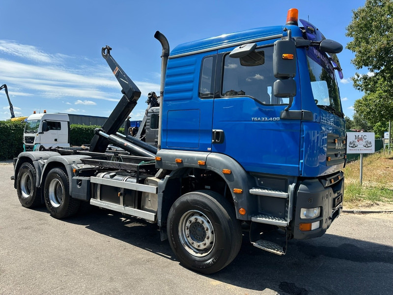 MAN TGA 33.400 6X4 HOOKLIFT AJK NHS20-4930mm - WB 3m60 - MANUAL ZF - STEEL SPRING / BLATT - BIG AXLES / AP ACHSEN - Camion ampliroll: photos 1 MAN TGA 33.400 6X4 HOOKLIFT AJK NHS20-4930mm - WB 3m60 - MANUAL ZF - STEEL SPRING / BLATT - BIG AXLES / AP ACHSEN - Camion ampliroll: photos 1