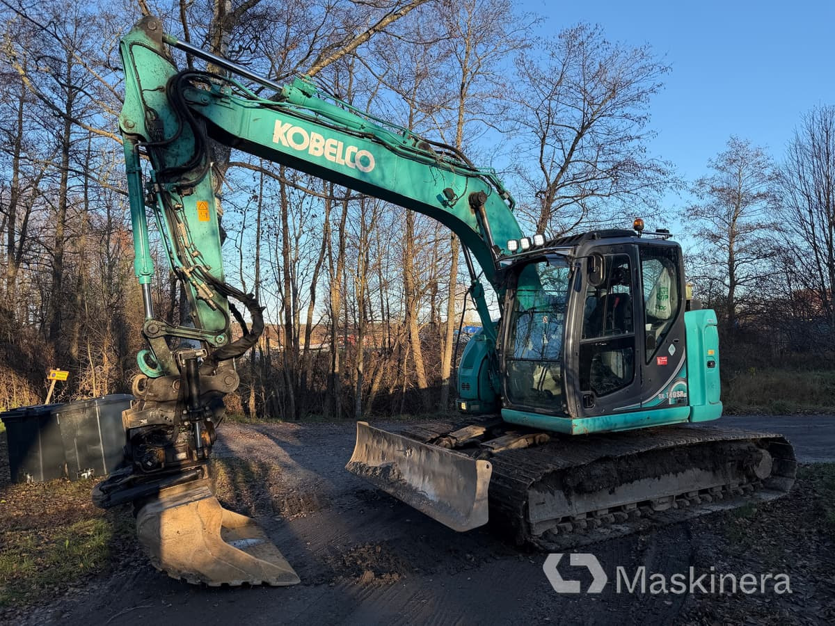 Grävmaskin Kobelco SK140SRLC-5 - Pelle sur chenille: photos 1 Grävmaskin Kobelco SK140SRLC-5 - Pelle sur chenille: photos 1
