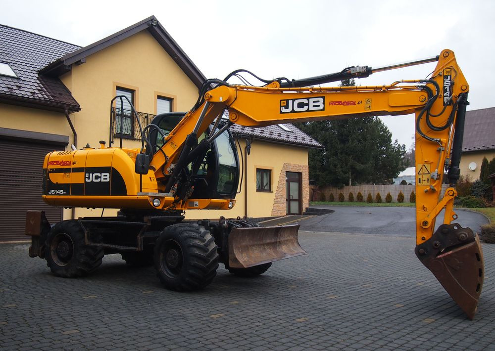 Koparka kołowa JCB JS145W 2011 Koparka JCB - Pelle sur pneus: photos 1 Koparka kołowa JCB JS145W 2011 Koparka JCB - Pelle sur pneus: photos 1