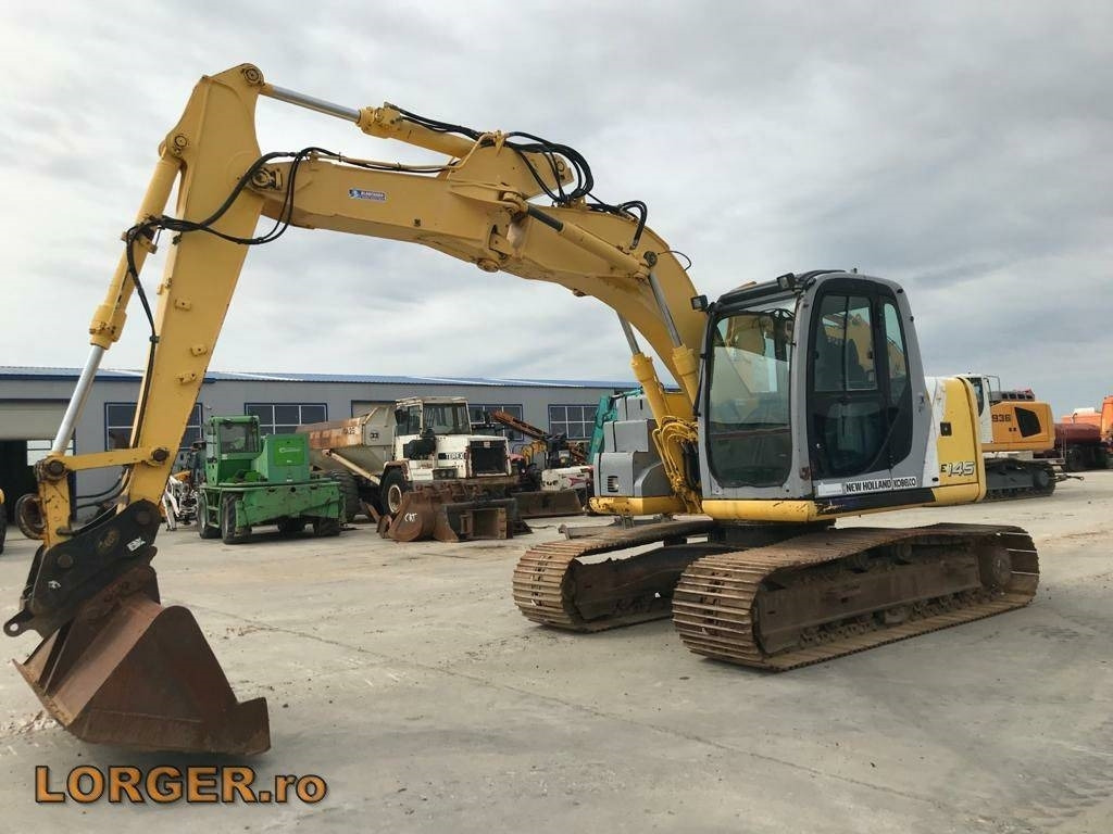 New Holland E 145 - Pelle sur chenille: photos 1 New Holland E 145 - Pelle sur chenille: photos 1