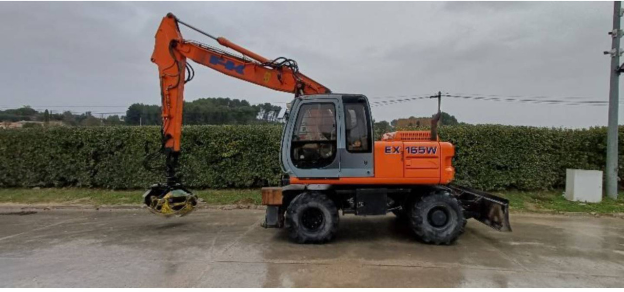 FIAT ALLIS / NEW HOLLAND EX165W - Pelle sur pneus: photos 1 FIAT ALLIS / NEW HOLLAND EX165W - Pelle sur pneus: photos 1