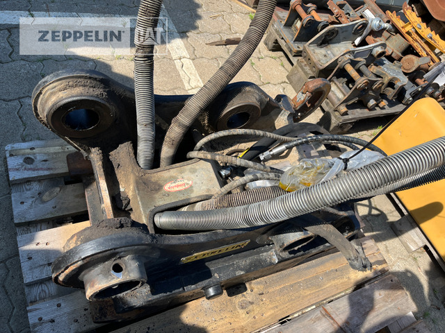 Oil-Quick OQ65  M312-M318F - Attache rapide pour Engins de chantier: photos 1 Oil-Quick OQ65  M312-M318F - Attache rapide pour Engins de chantier: photos 1